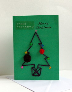 dark wool christmas tree in pot with pom pom and gem sticker decorations merry Christmas card